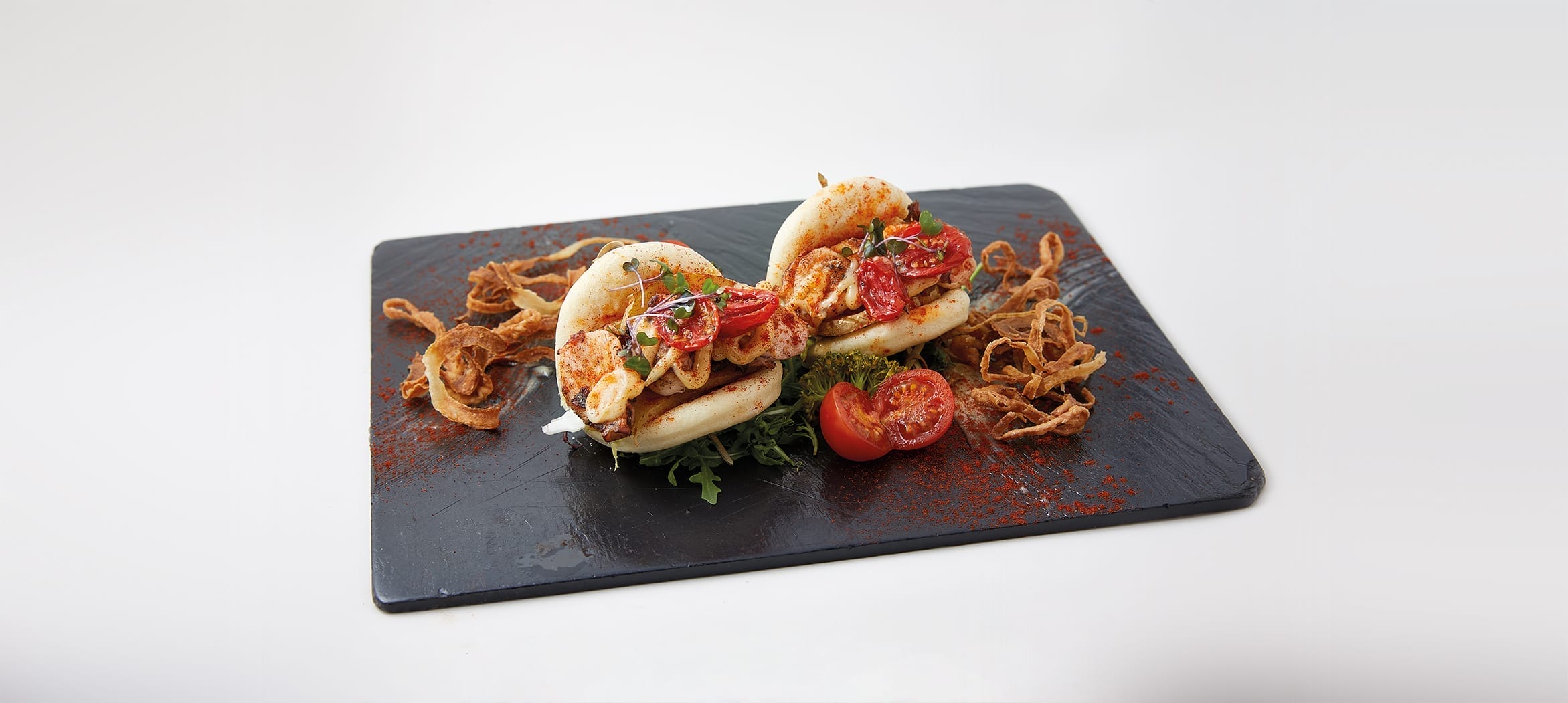 Bao de pulpo con patata paja, brotes tiernos y alioli de miel.